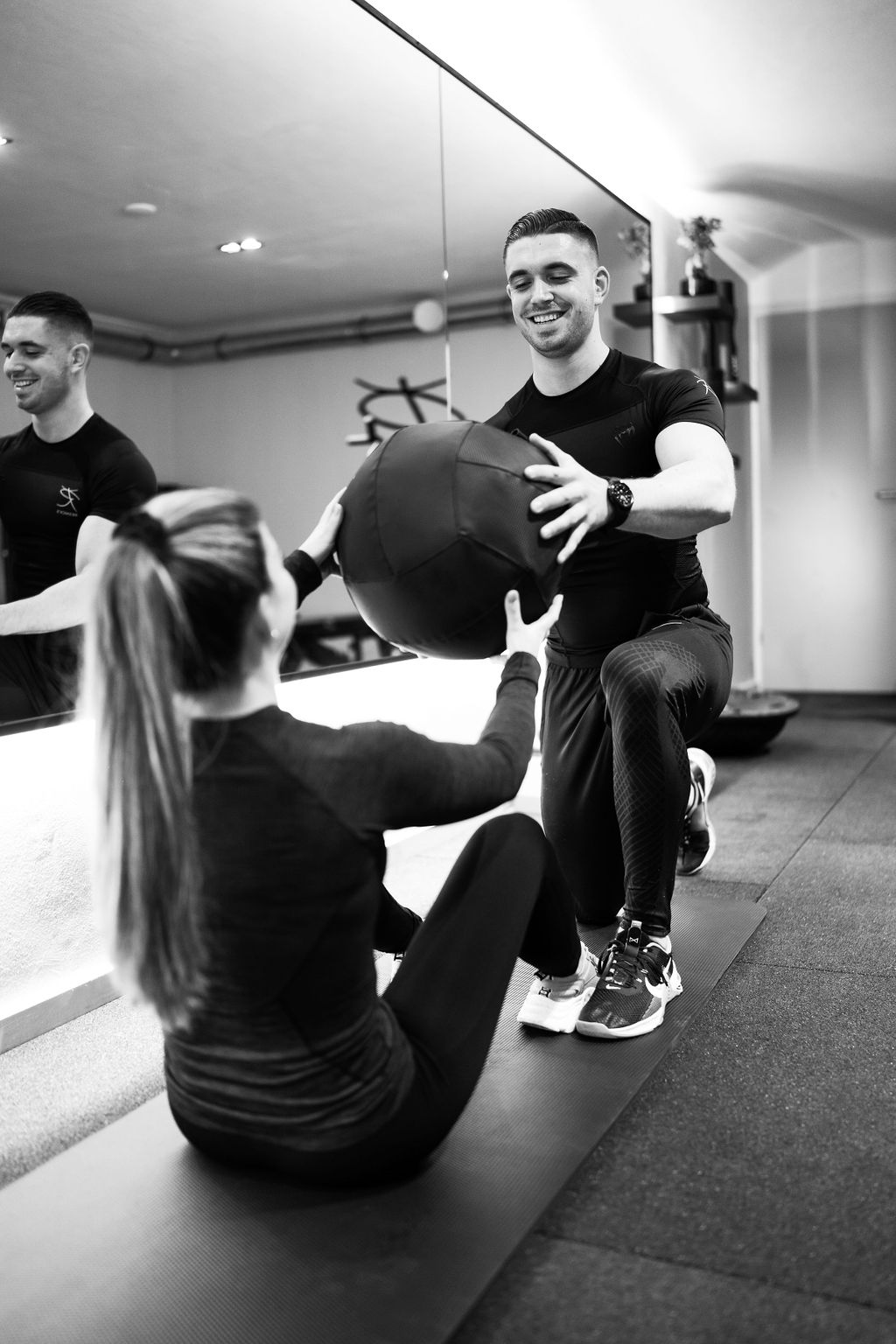 Jason guiding a client through a medicine-ball exercise at Resnick’s private studio